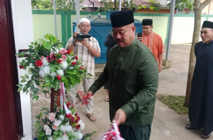Bupati Kukar Edi Damansyah menyerahkan kartu peserta Bimtek dan meresmikan fasilitas masjid.